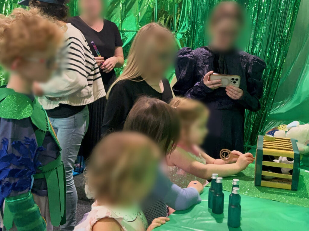 Kids unlocking a DIY cage with a key after solving scavenger hunt clues during a fantasy themed party, featuring interactive puzzles and adventure activities.